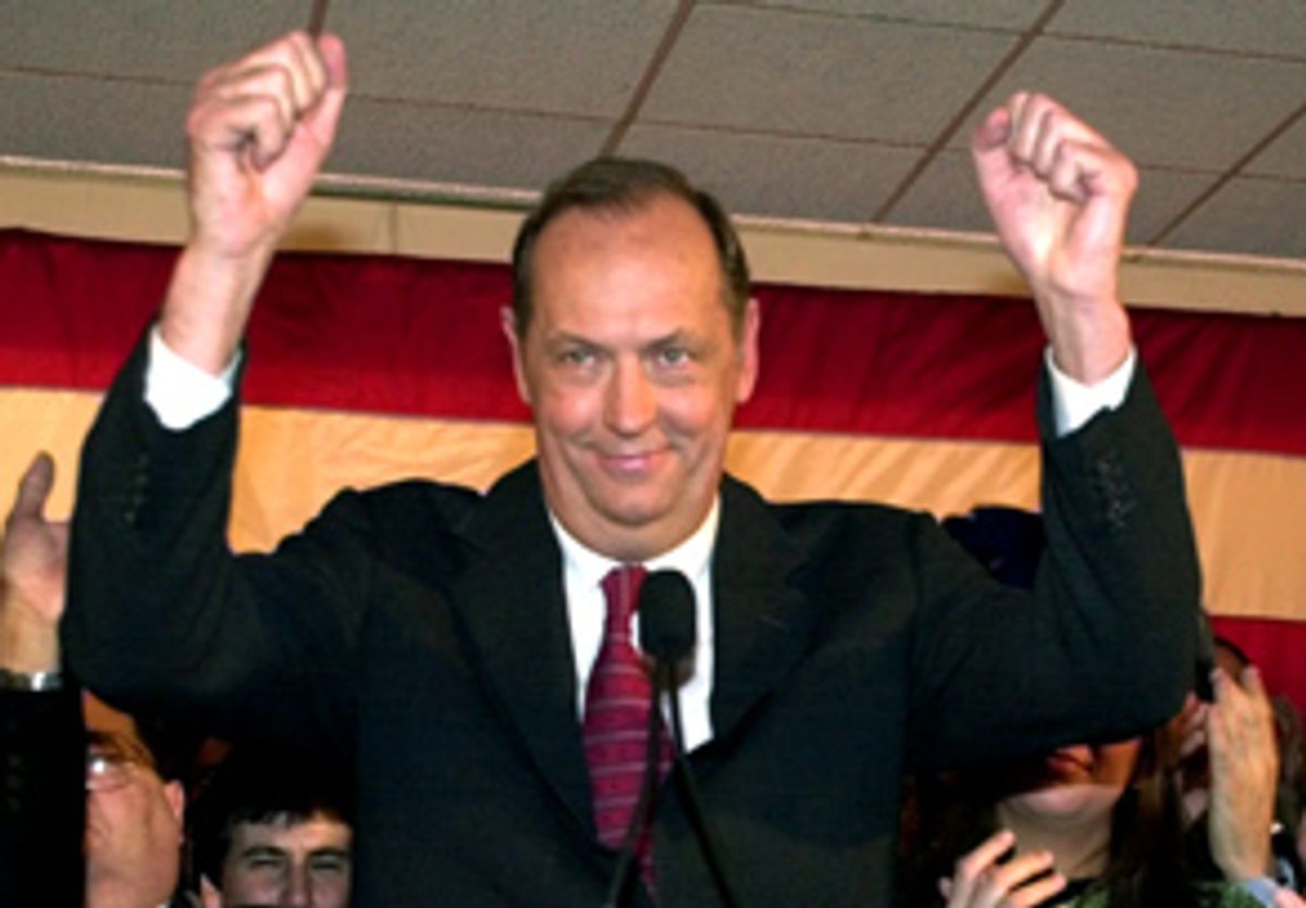 Democratic presidential hopeful Bill Bradley raises his hands to his supporters as his wife Ernestine Schlant Bradley, right, applauds him during a Super Tuesday rally in New York City Tuesday, March 7, 2000. (AP Photo/Charles Rex Arbogast) (Associated Press)