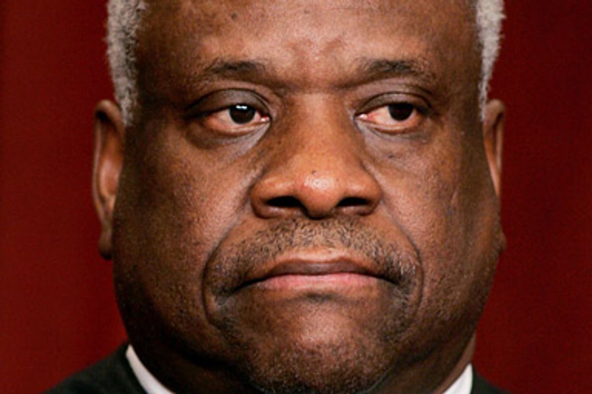 Justice Clarence Thomas sits as Justices of the Supreme Court of the United States pose for a 2006 class photo inside the Supreme Court in Washington March 3, 2006.    