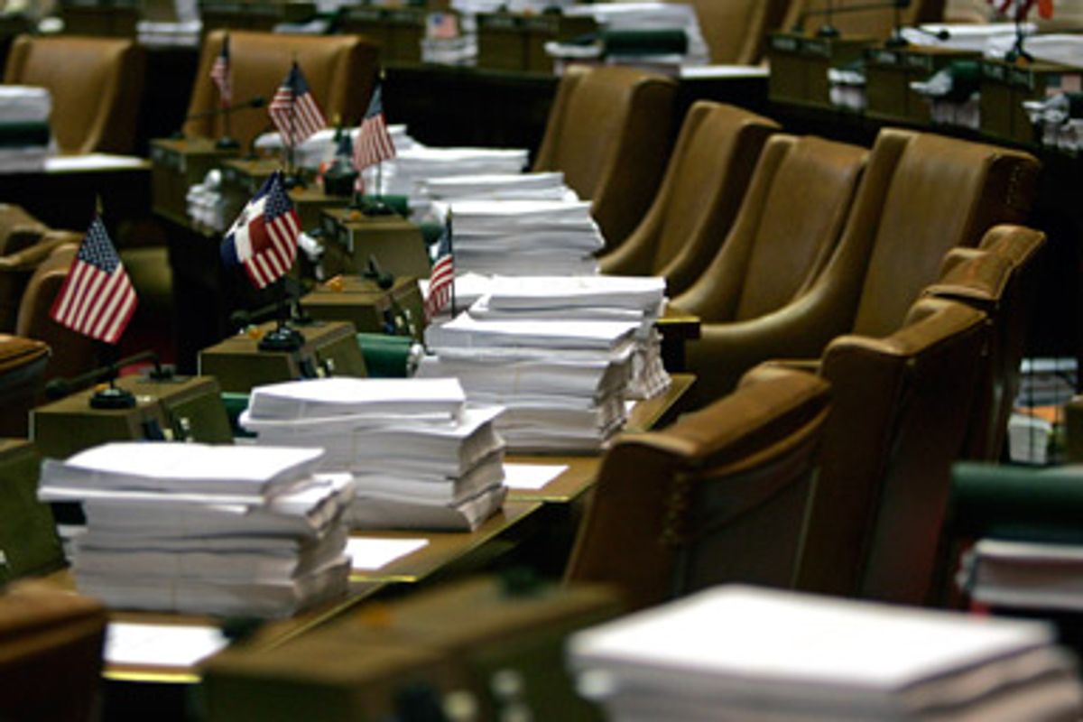 Budget bills are piled on legislators' desks in the Assembly Chamber at the Capitol in Albany, N.Y., Monday, March 30, 2009.