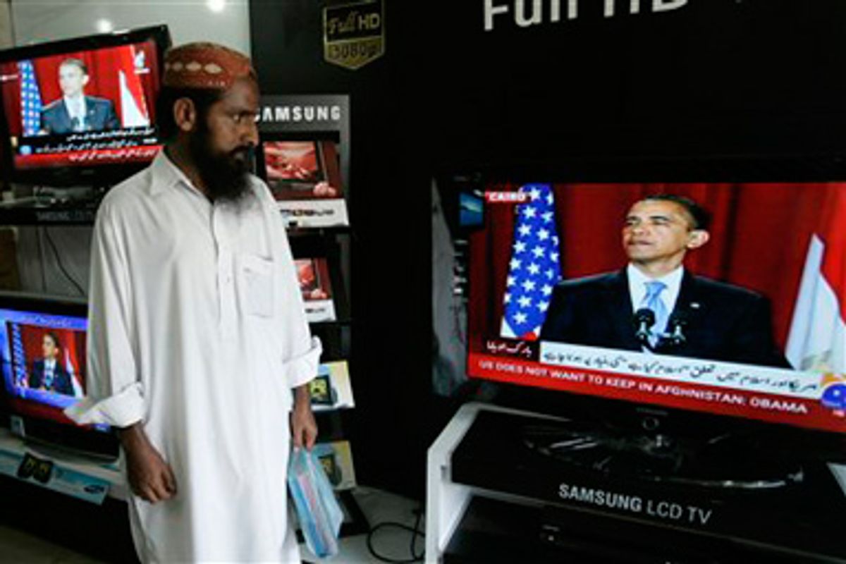 Pakistanis listen to President Barack Obama's speech at an electronic shop in Karachi, Pakistan on Thursday, June 4, 2009. 
