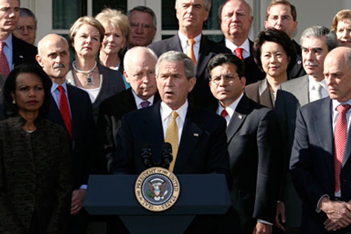 Surrounded by members of his cabinet, U.S. President George W. Bush speaks in the Rose Garden of the White House after a cabinet meeting in Washington November 9, 2006. 