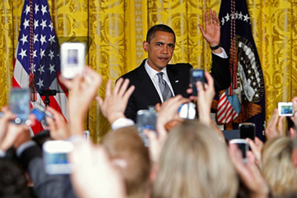 U.S. President Barack Obama waves to the crowd as he arrives to address a reception for the LGBT Pride (Gay and Lesbian Pride) Month in the East Room at the White House in Washington June 29, 2009.