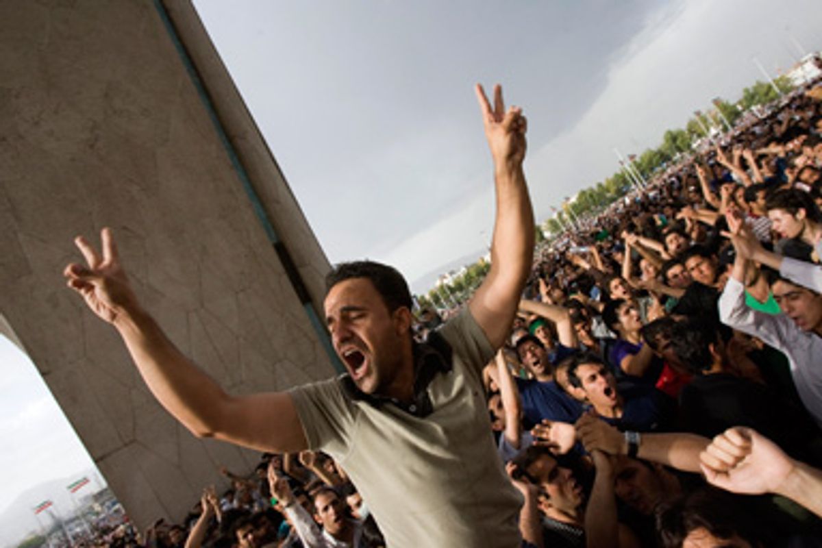 A supporter of defeated presidential candidate Mirhossein Mousavi flashes victory signs as he shouts slogans during a rally in Tehran June 15, 2009.
