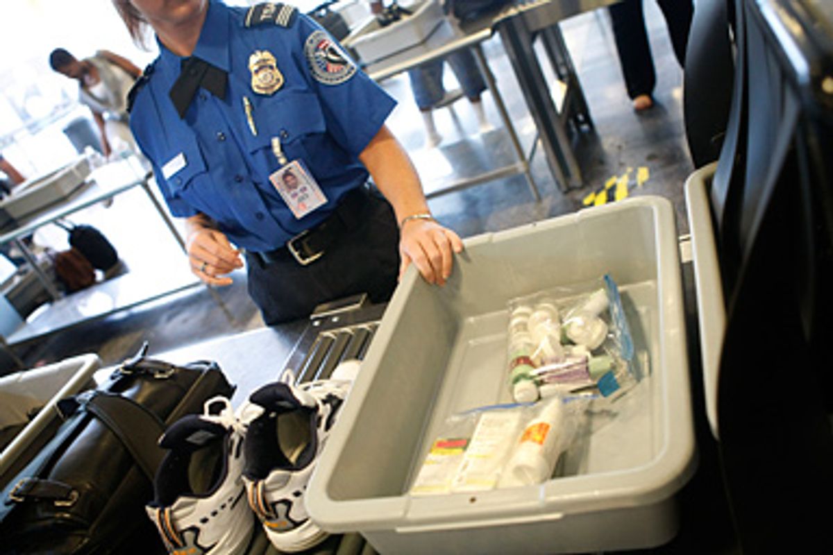 A TSA supervisor guides items into the X-ray machine at Ronald Reagan National Airport in Washington in 2008.