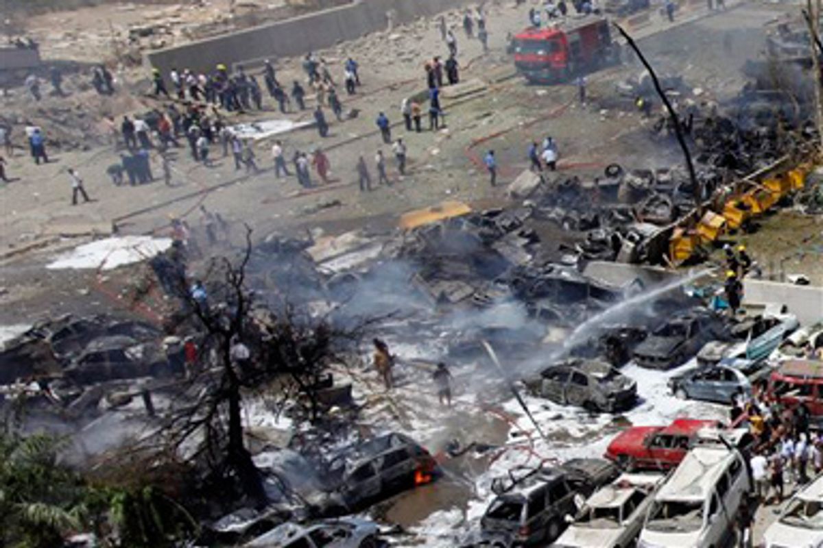 Fire fighters respond to a bombing near the Iraqi Foreign Ministry in Baghdad, Iraq, Wednesday, Aug. 19, 2009.