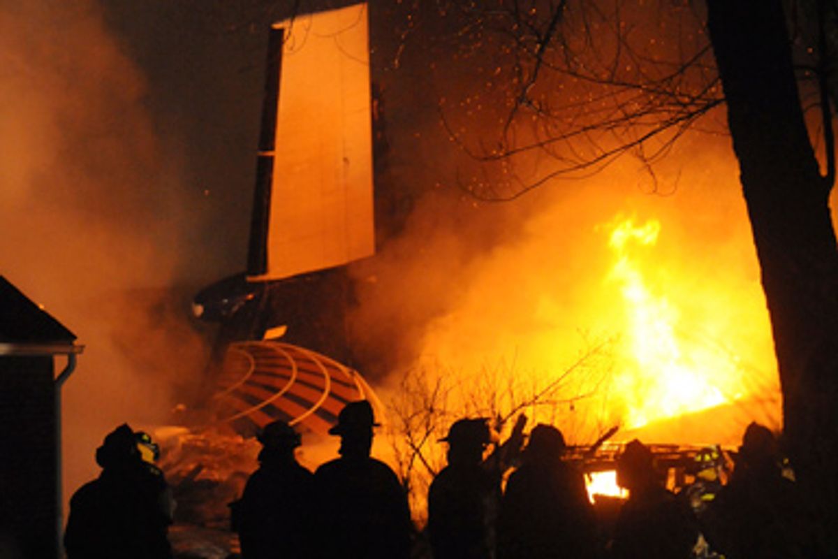 Firefighters are seen at the site of the wreckage of a plane, a Continental Connection flight operated by Colgan Air, which crashed in Clarence, near Buffalo, New York February 13, 2009.