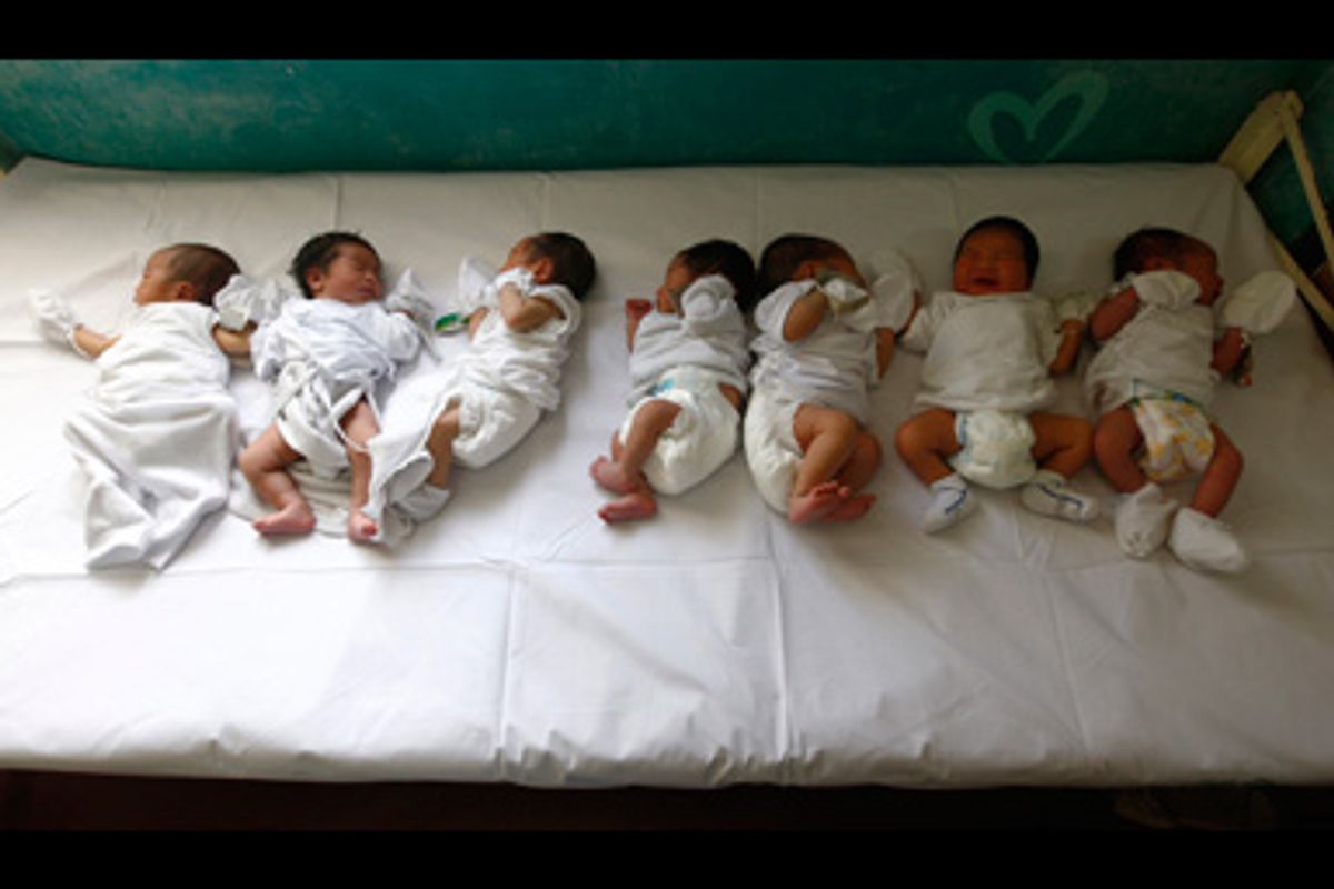 Babies rest on a bed inside a maternity ward at a hospital in Manila November 14, 2008.