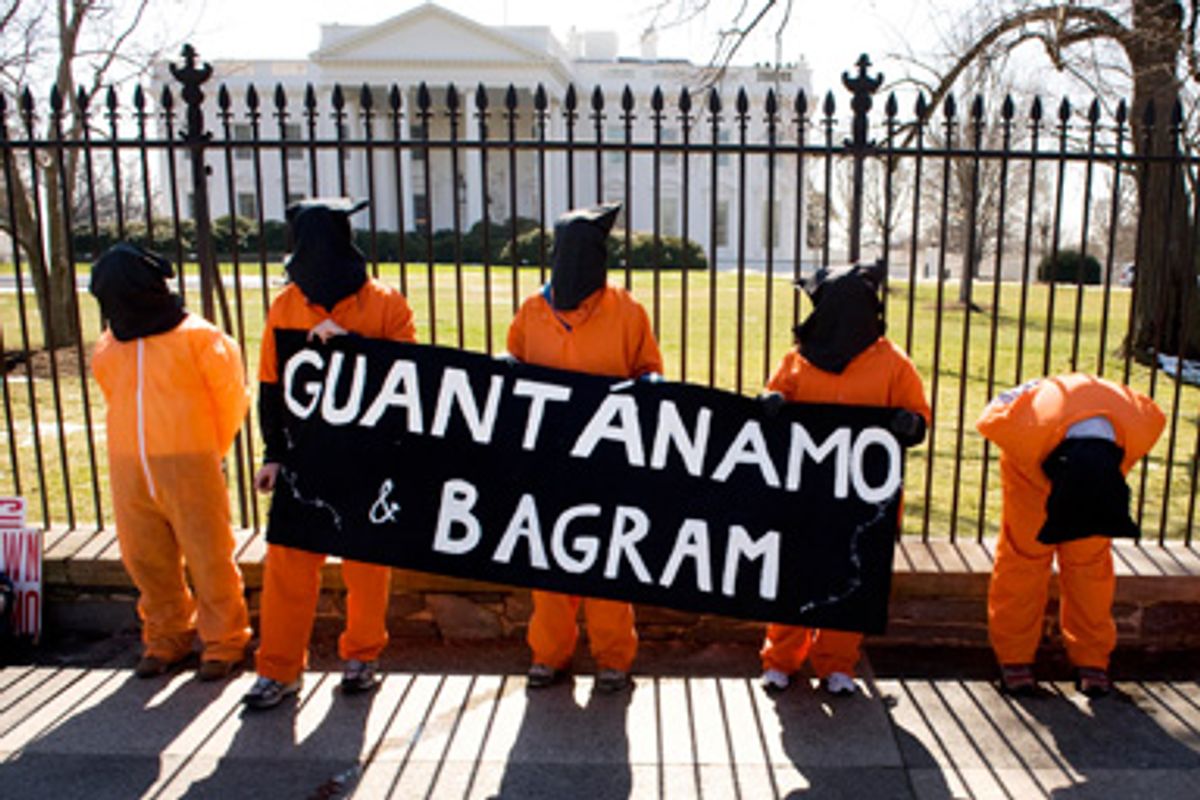 Protesters calling for the closing of the U.S.detention facilities at Guantanamo Bay, Cuba, and at Bagram Air Base, Afghanistan, stand outside of the White House in Washington, March 5, 2009.  