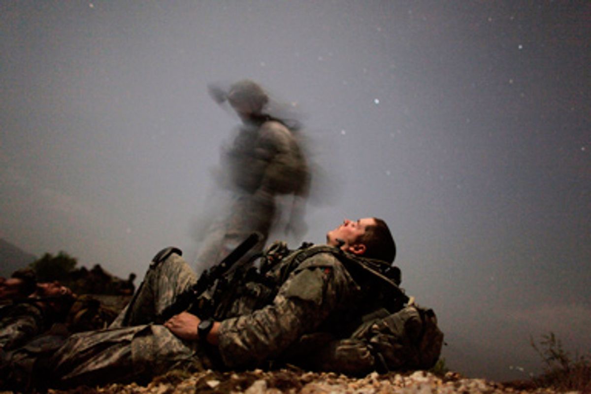 A U.S. soldier of 2-12 Infantry 4BCT-4ID Task Force Mountain Warrior takes a break during a night mission near Honaker Miracle camp at the Pesh valley of Kunar Province August 12, 2009.