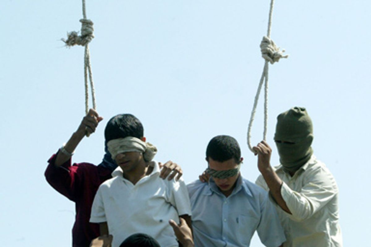 Blindfolded Mahmoud Asgari, 16, left, and another unidentified teenager are set to be publicly hanged, in Mashhad, Iran, on charges of raping boys in this photo taken on July 19, 2005.   
