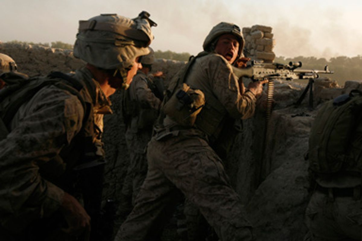 U.S. marines fire during a Taliban ambush as they carry out an operation to clear an area in Helmand province, October 9, 2009. 