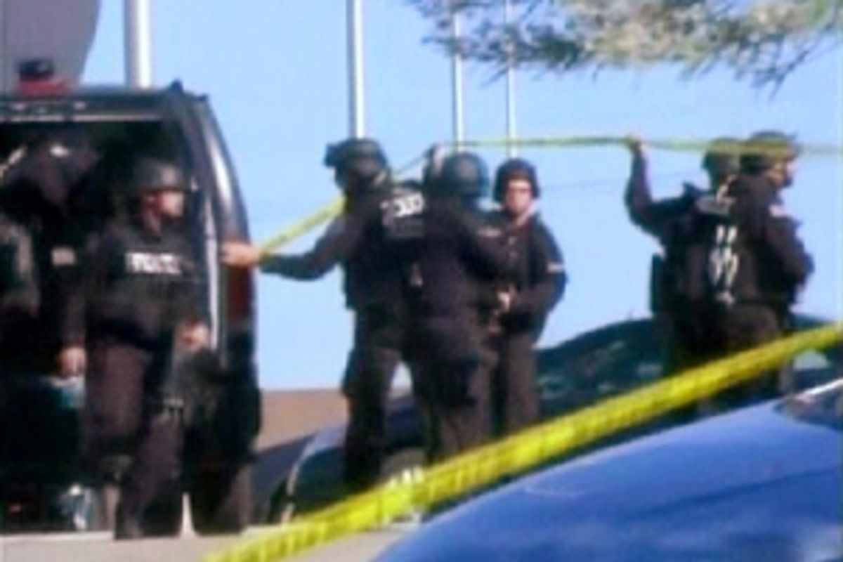 ** DELETES SECOND SENTENCE TO UPDATE ARMY'S ANNOUNCEMENT THAT GUNMAN IS ALIVE ** In this image made from Associated Press Television video, police respond at the scene at the U.S. Army base in Fort Hood Texas where a soldier opened fire, unleashing a stream of gunfire that left at least 12 people dead and at least 31 wounded. (AP Photo/APTN)    (AP)