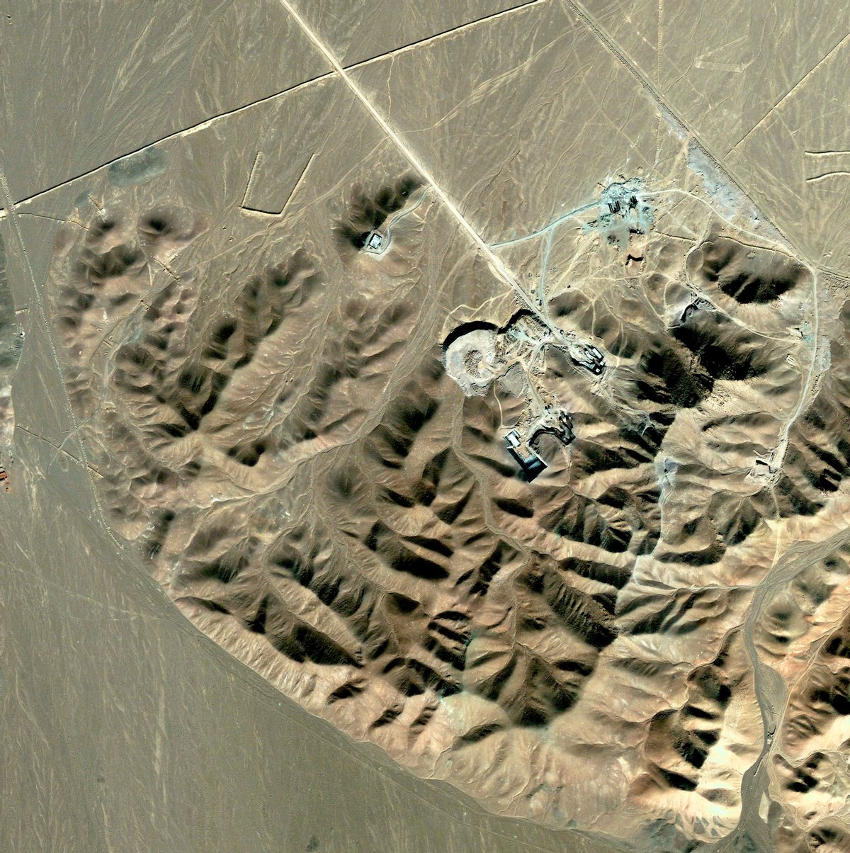 A view of what is believed to be a uranium-enrichment facility near Qom, Iran, is seen in this satellite photograph released September 25, 2009. Iranian President Mahmoud Ahmadinejad said Friday the United States, Britain and France would "regret" accusing Iran of hiding a nuclear fuel facility, saying it was not a secret site. REUTERS/DigitalGlobe/Handout (IRAN SCI TECH POLITICS IMAGES OF THE DAY) FOR EDITORIAL USE ONLY. NOT FOR SALE FOR MARKETING OR ADVERTISING CAMPAIGNS. MANDATORY CREDIT (Reuters)
