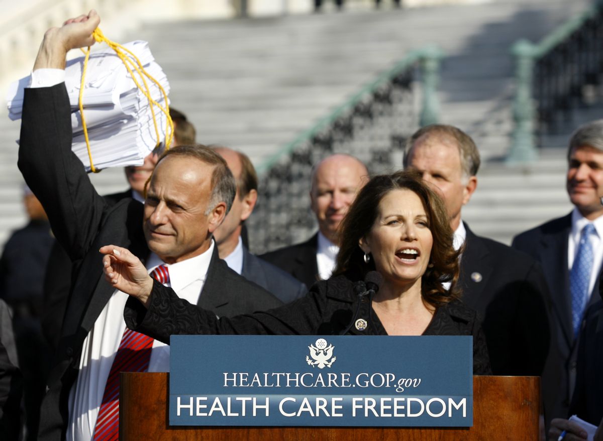 Rep. Michelle Bachmann R-Min., addresses the crowd on Capitol Hill in Washington, Thursday, Nov. 5, 2009, during a Republican health care news conference. Rep. Steve King., R-Iowa, holds the health care bill at left. (AP Photo/Jose Luis Magana)  (Associated Press)