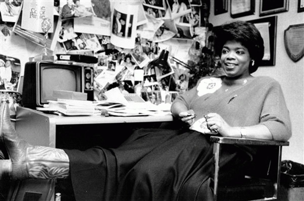 In this Dec. 18, 1985 file photo,  Winfrey puts her feet up as she relaxes in her studio office following a morning broadcast in Chicago, Ill.