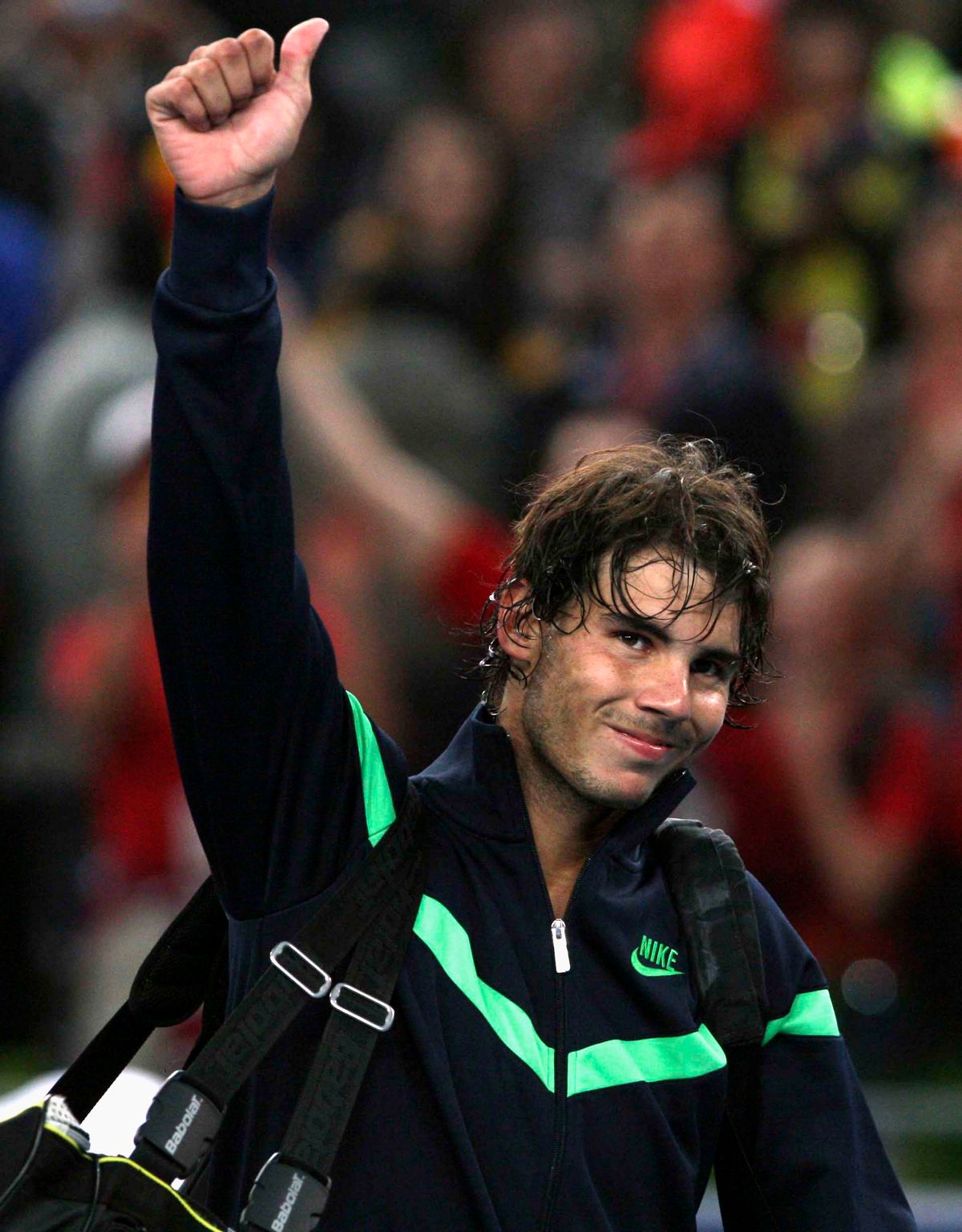 Spain's Rafael Nadal gives Chinese fans a thumbs up after winning over James Blake of the United States in the second round of the China Open tennis tournament in Beijing Thursday, Oct. 8, 2009. Nadal won 7-5, 6-7, 6-3 against Blake. (AP Photo/Elizabeth Dalziel)    (Elizabeth Dalziel)