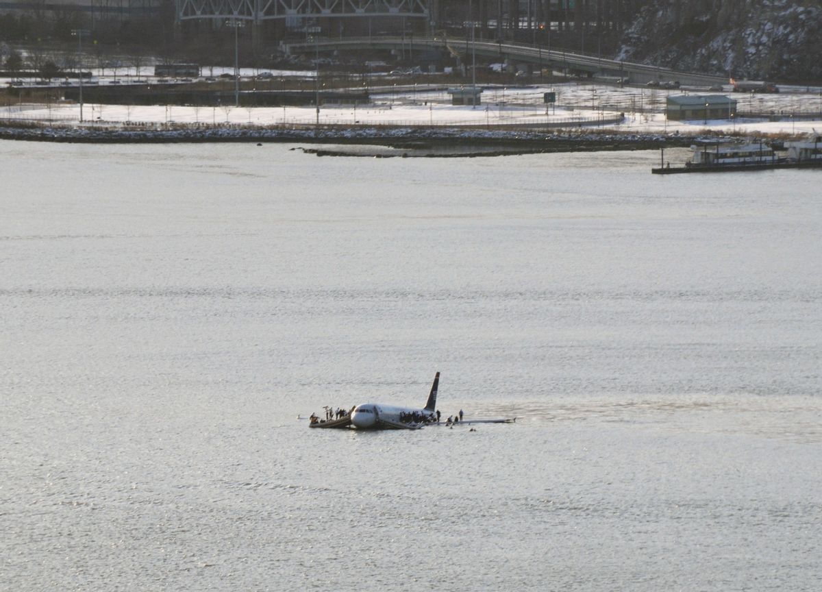 A US Airways jetliner is seen after it crashed into the Hudson River Thursday afternoon, Jan. 15, 2009 after a flock of birds apparently disabled both its engines. Rescuers pulled the more than 150 passengers and crew members into boats before the plane sank, authorities say. Federal Aviation Administration spokeswoman Laura Brown said Flight 1549 had just taken off from LaGuardia Airport en route to Charlotte, N.C., when the crash occurred in the river near 48th Street in midtown Manhattan. (AP Photo/Greg Lam Pak Ng) (A. G. Lam Pak Ng)