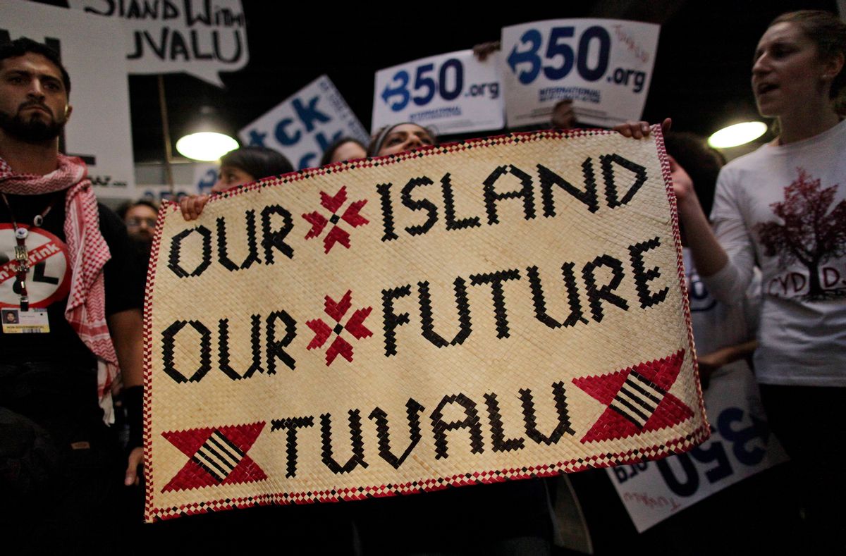 Activists supporting the tiny Pacific island of Tuvalu demonstrate in the lobby of the Bella center demanding a better deal for all island states at the UN Climate summit in Copenhagen, Denmark, Wednesday, Dec. 9, 2009. The Pacific island of Tuvalu has been rebuffed at Copenhagen after demanding strong action to curb global warming.Tuvalu proposed amending the U.N. climate treaty to require the world's nations to keep the rise in temperatures to 1.5 degrees C (2.7 degrees F) above preindustrial levels. (AP Photo/Anja Niedringhaus)  (Associated Press)