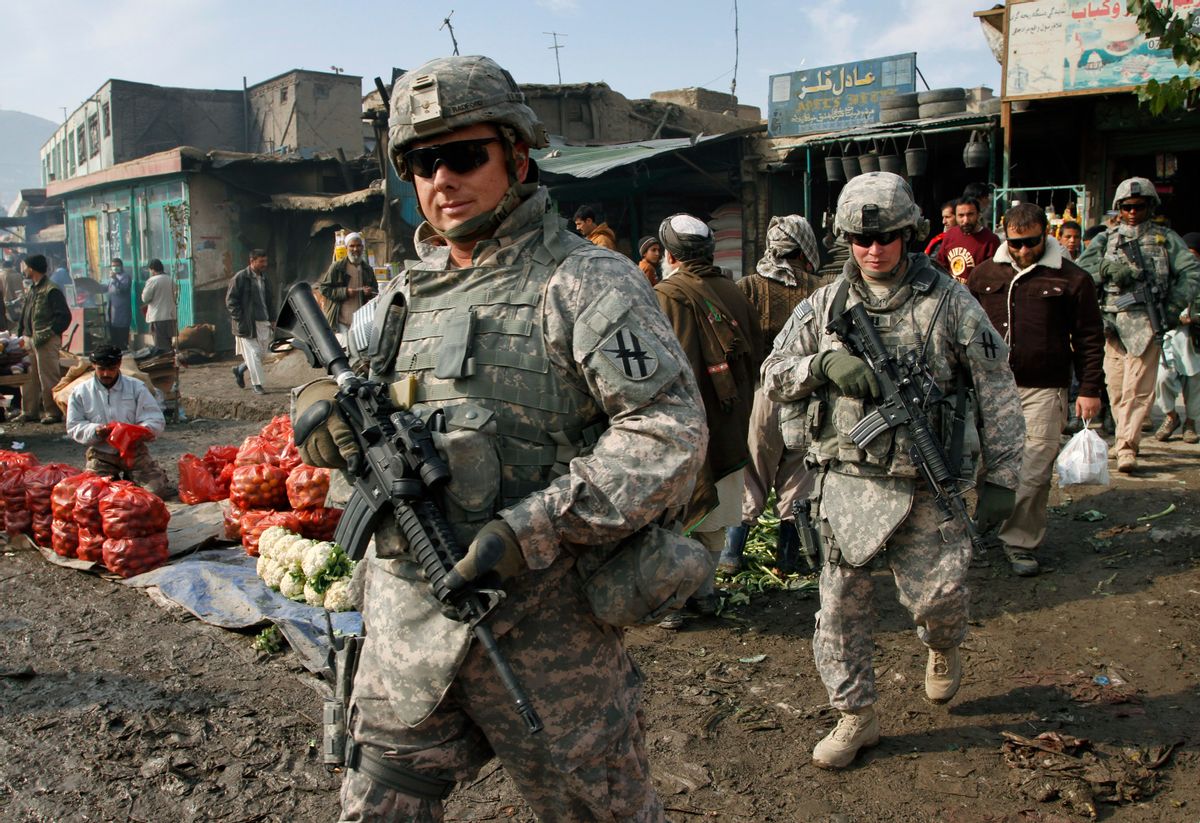 U.S. soldiers patrol through the heart of Kabul, Afghanistan on Wednesday, Dec. 2, 2009.  Many Afghans were still sleeping when President Barack Obama announced he was sending 30,000 more U.S. troops to the war. Gen. Stanley McChrystal, the top U.S. commander in Afghanistan, said NATO and U.S. forces would hand over responsibility for securing the country to the Afghan security forces "as rapidly as conditions allow." Obama said if conditions are right, U.S. troops could begin leaving Afghanistan in 18 months. (AP Photo/Musadeq Sadeq) (Associated Press)