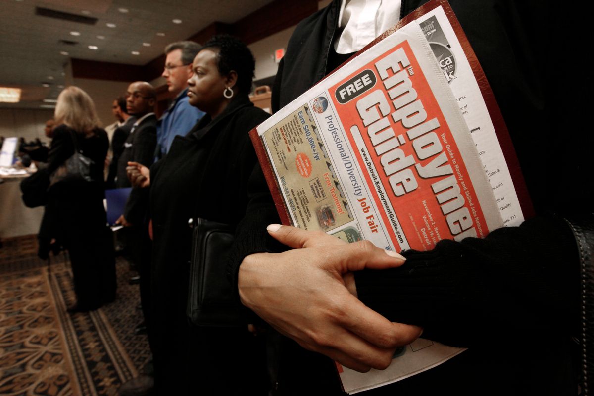 Sonja Jackson, of Detroit, holds a Employment Guide  standing in line while attending a job fair in Livonia, Mich., Wednesday, Nov. 4, 2009.   (AP Photo/Paul Sancya)   (Paul Sancya)