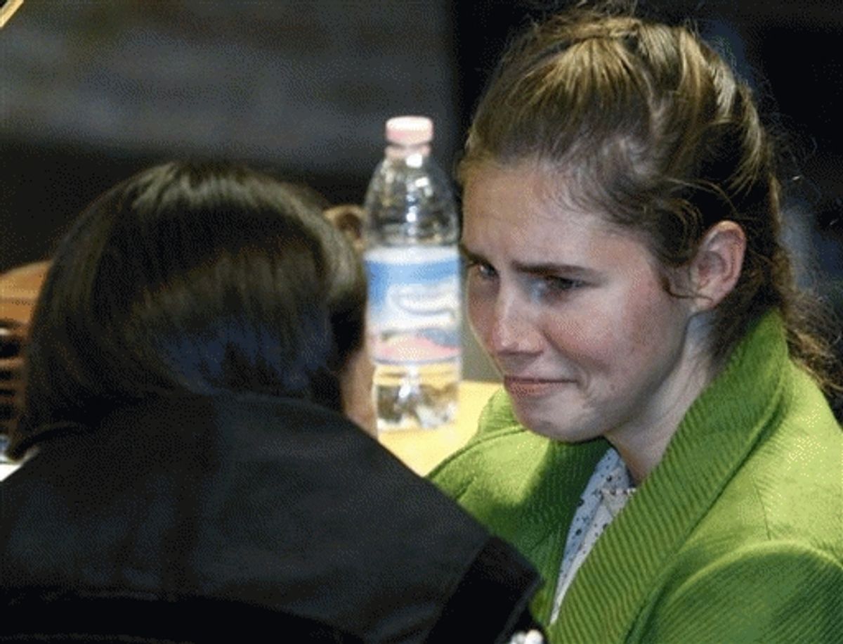 U.S. murder suspect Amanda Knox talks to a lawyer prior to a defense hearing at the court in Perugia, central Italy, Thursday, Dec. 3, 2009. 