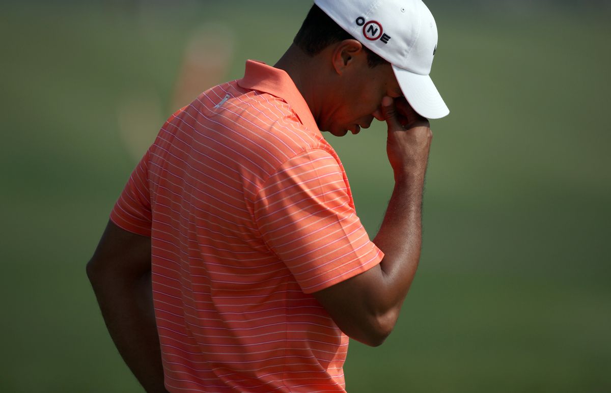Tiger Woods of the U.S. reacts after taking a shot on the 14th hole during the 2009 HSBC Champions golf tournament in Shanghai November 5, 2009. REUTERS/Nir Elias (CHINA SPORT GOLF)   (Reuters)