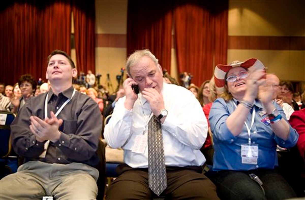 Paul Poyfair, Lincoln City, Ore. center, takes a phone call while his son, James Poyfair, left, and Deborah Lane, Crescent City, Fla. applaud during former Florida House Speaker Marco Rubio's address to the Conservative Political Action Conference (CPAC), in Washington, Thursday, Feb. 18, 2010. (AP Photo/Cliff Owen) (AP)