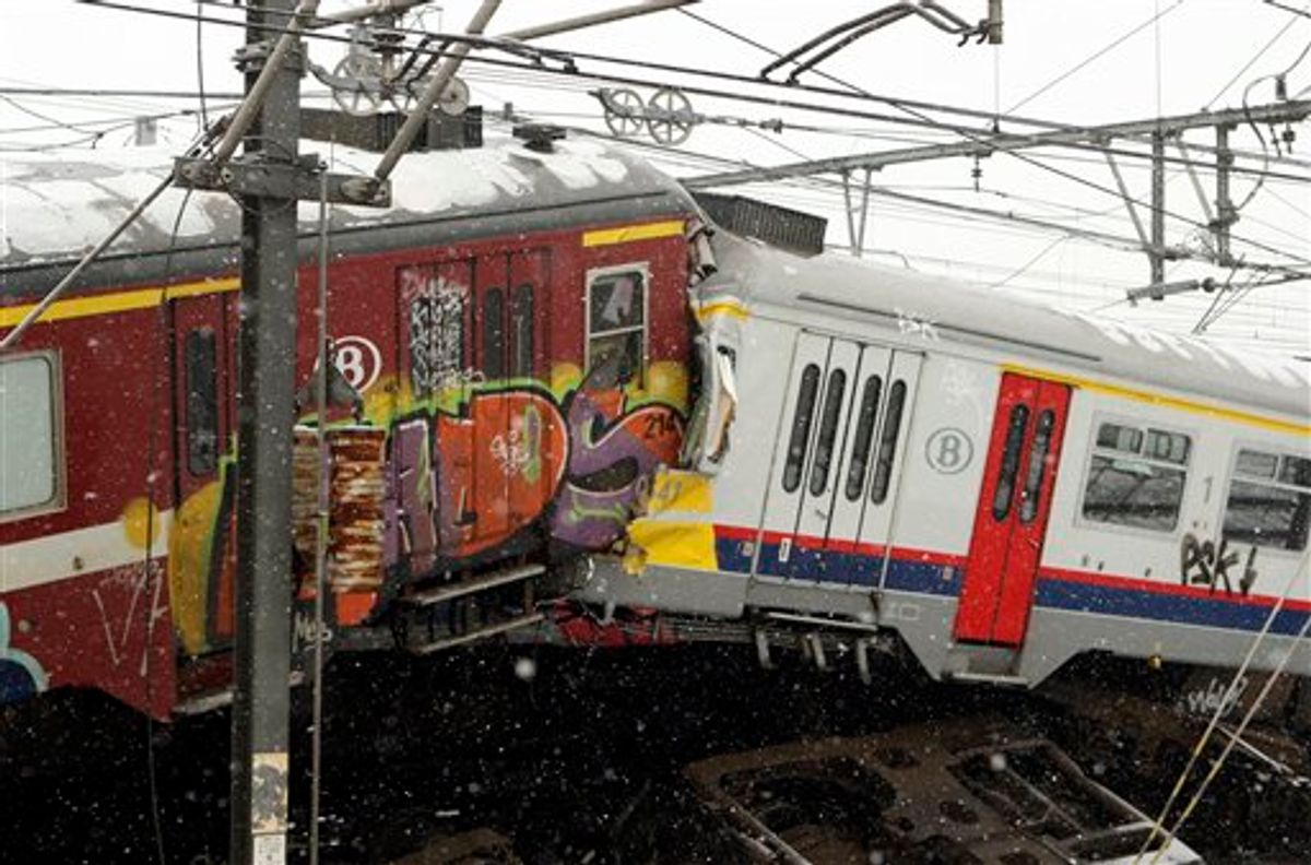 The wreckage of two commuter trains is seen in Buizingen, Belgium Monday, Feb. 15, 2010. Two commuter trains collided head-on at rush hour in a Brussels suburb Monday, killing 20 people, Belgian officials said. (AP Photo/Yves Logghe) (AP)