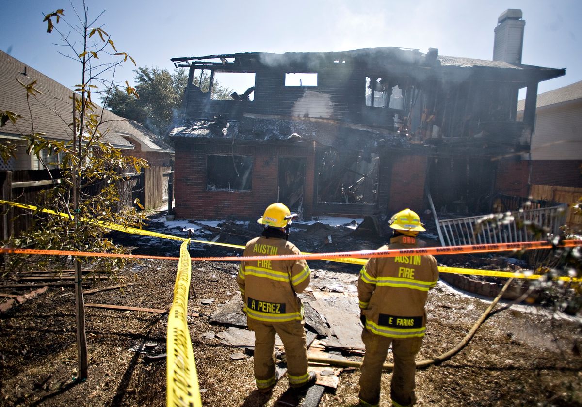 Two firemen are seen at the home belonging to Joseph Stack, after Stack apparently set  it on fire according to two law enforcement officials, Thursday morning on Feb. 18, 2010 in Austin, Texas. Stack, a software engineer furious with the Internal Revenue Service plowed his small plane into an office building housing nearly 200 federal tax employees on Thursday, officials said, setting off a raging fire that sent workers fleeing as thick plumes of black smoke poured into the air. (AP Photo/ Thao Nguyen)  (AP)