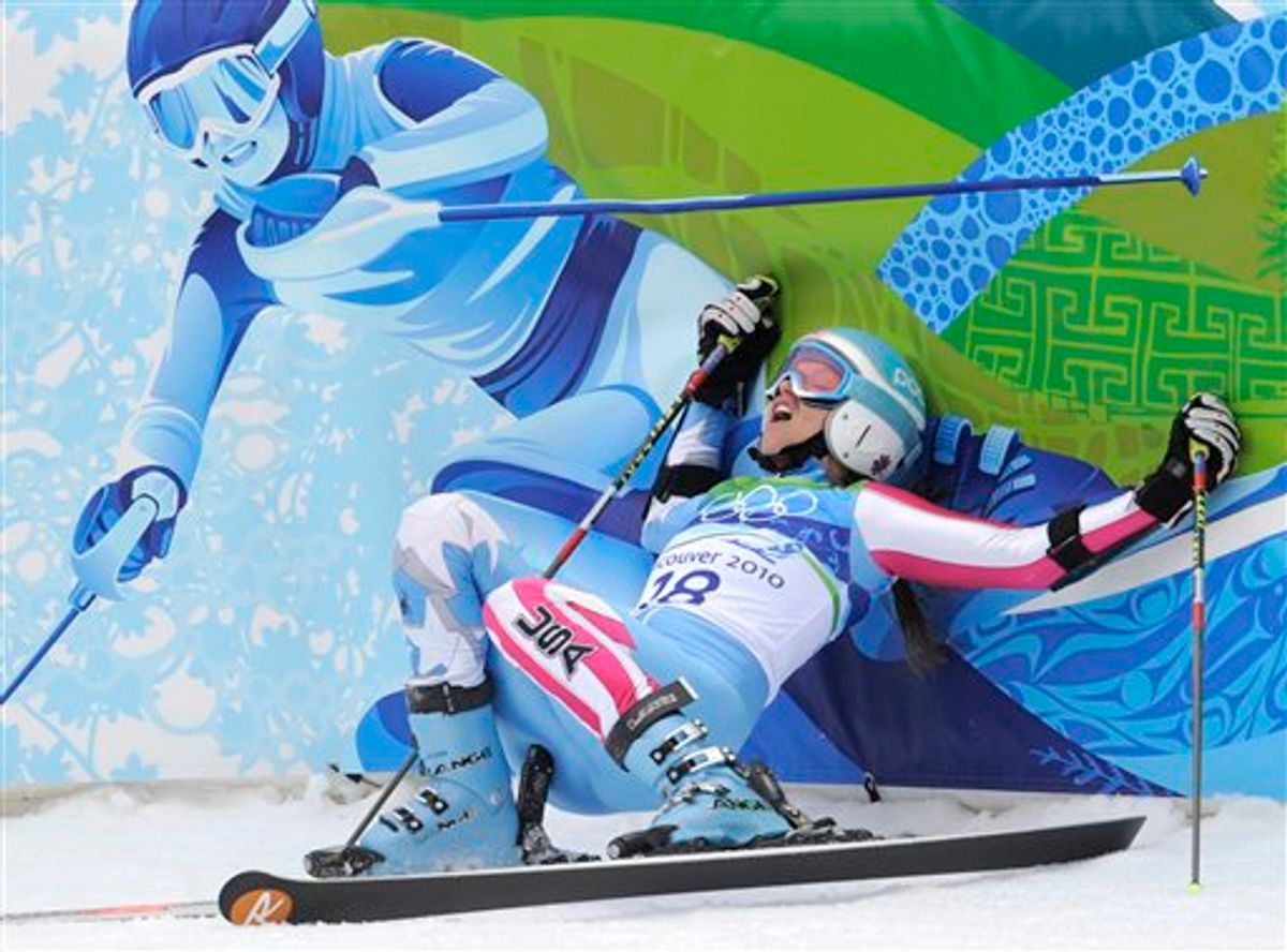 Julia Mancuso of the United States falls back on to the finish area fencing after finishing the second run of the Women's giant slalom, at the Vancouver 2010 Olympics in Whistler, British Columbia, Thursday, Feb. 25, 2010. (AP Photo/Gero Breloer) (AP)