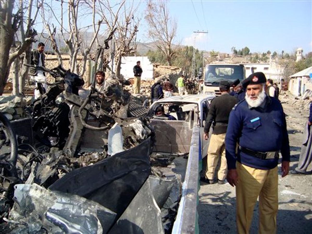 A Pakistani police officer looks at remains of a vehicle destroyed by a bomb explosion in Lower Dir, Pakistan on Wednesday, Feb. 3, 2010. Three U.S. soldiers traveling with Pakistan security force members were killed Wednesday in a roadside bombing near a girl's school in northwest Pakistan, Pakistani security officials said. Other casualties included school children. (AP Photo/ Naveed Ali) (AP)