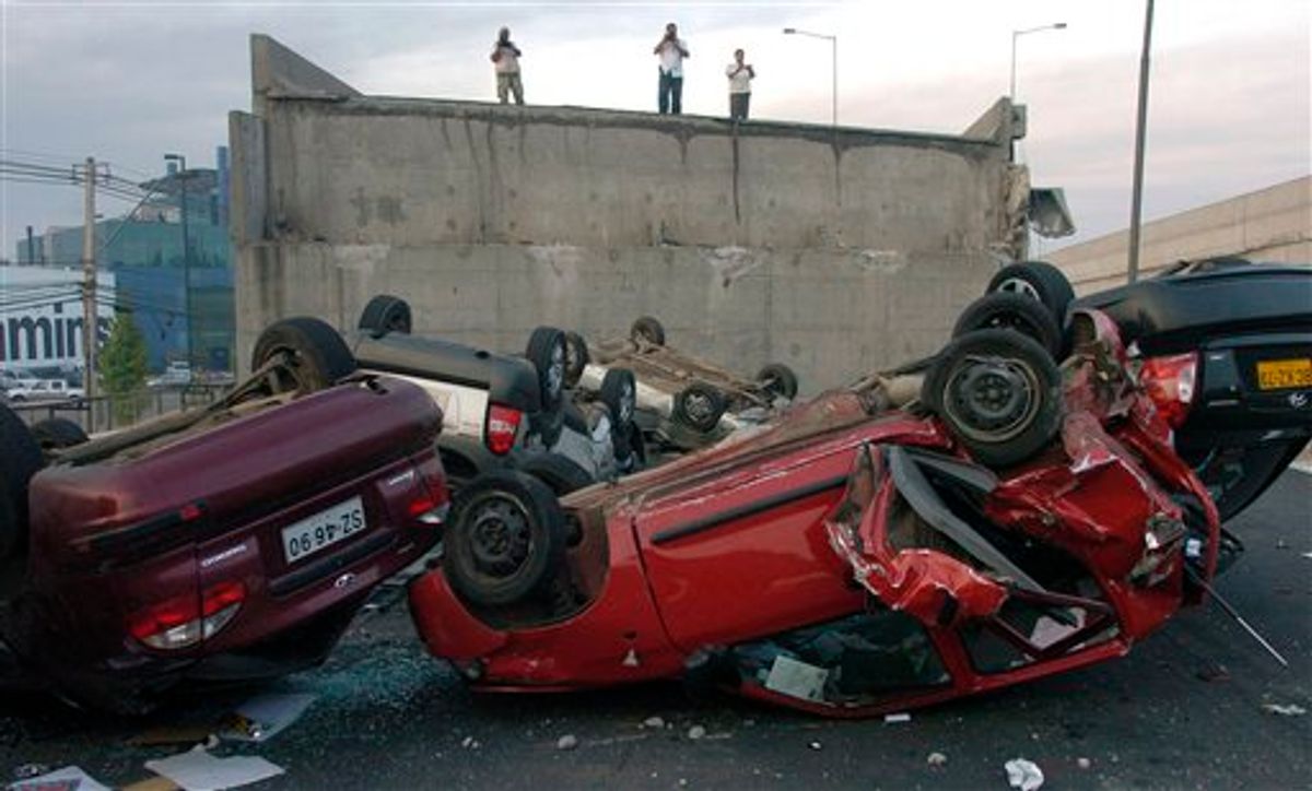 Vehicles that were driving along a highway that collapsed near Santiago are seen overturned  on the asphalt Saturday, Feb. 27, 2010 after a powerful earthquake struck central Chile early Saturday.(AP Photo/Carlos Espinoza) (AP)