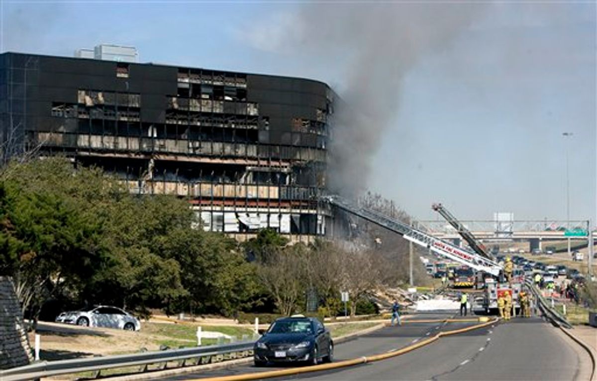 Smoke billows from a seven-story building after a small private plane crashed into the building  in Austin, Texas on Thursday Feb. 18, 2010. (AP Photo/Austin American-Statesman, Jay Janner/) MANDATORY CREDIT. NO MAGS, NO SALES, NO TV  (AP)