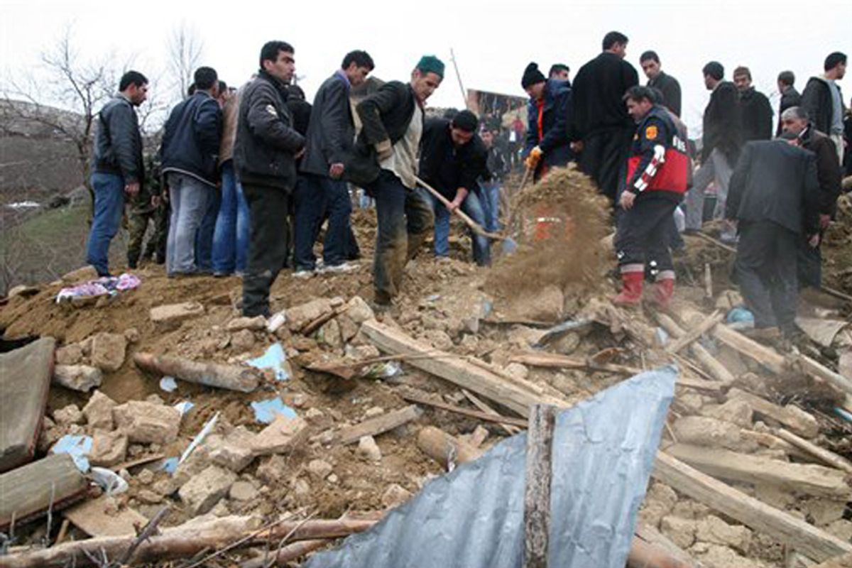 Rescue workers remove rubble from a destroyed house in eastern Turkey after an earthquake on Monday.   