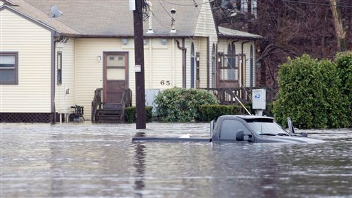 An abandoned truck sits in flood water on Industrial Lane in West Warwick, R.I.,Tuesday, March 30, 2010. The Pawtuxet River is predicted to hit a record stage of 17.5 feet, eight feet above floor stage.  (AP Photo/Stew Milne) (AP)