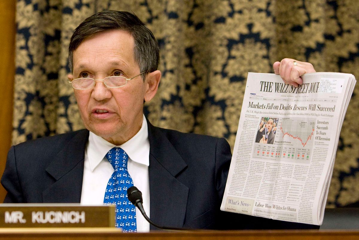 Rep. Dennis Kucinich (D-Ohio) holds up today's Wall Street Journal at the U.S. House Oversight and Government Reform Committee hearing on the cause and effects of the AIG bailout on Capitol Hill, October 7, 2008.   REUTERS/Larry Downing  (UNITED STATES) (Reuters)