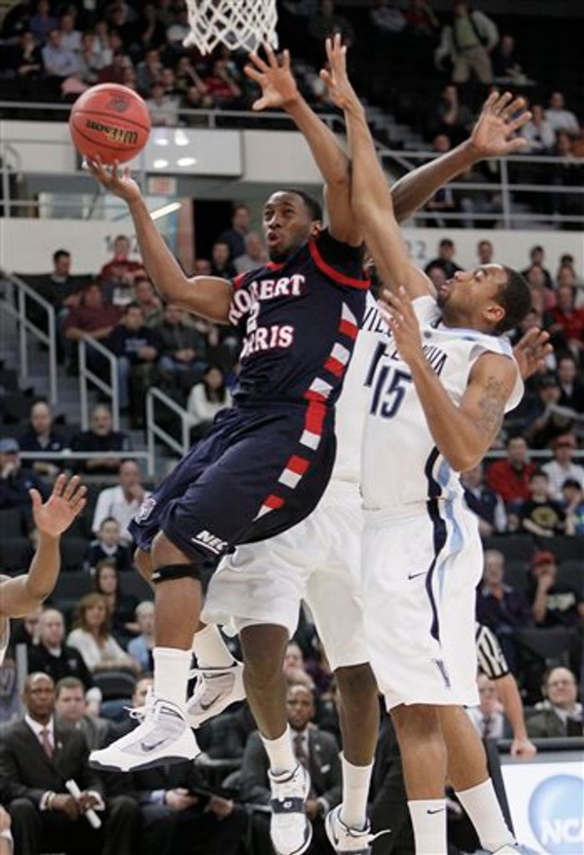 Robert Morris' Mezie Nwigwe (2) drives past Villanova's Reggie Redding (15) during the first half of an NCAA first-round college basketball game in Providence, R.I., Thursday, March 18, 2010. (AP Photo/Winslow Townson)  (AP)