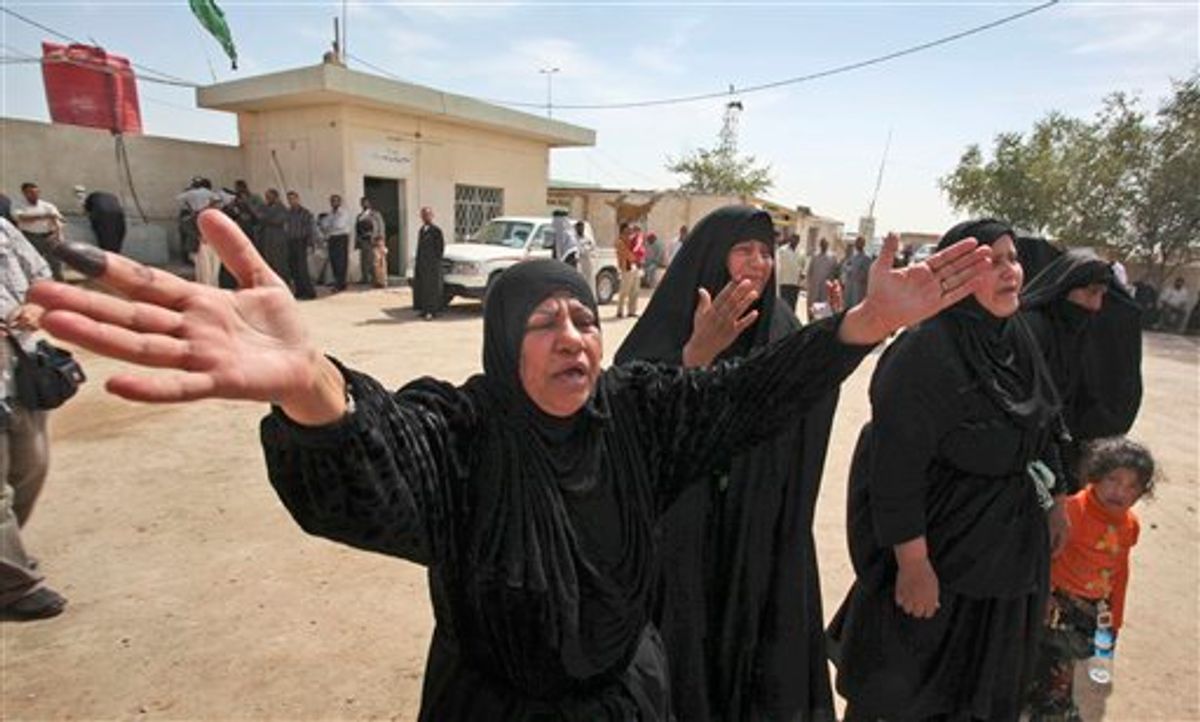 The mother, center-left, of Fayha Kadim, 23, and Fayha's son Muntadhar Waleed, 3, who were both killed in blasts in northeastern Baghdad Sunday, grieves at their funeral in Najaf, Iraq, Monday, March 8, 2010, while her finger still bears the ink of those who voted.  The election day's death toll was 36, with various incidents of rockets and mortars, hand grenades and bombs all being used to target polling stations and the people voting. (AP Photo/Alaa al-Marjani) (AP)