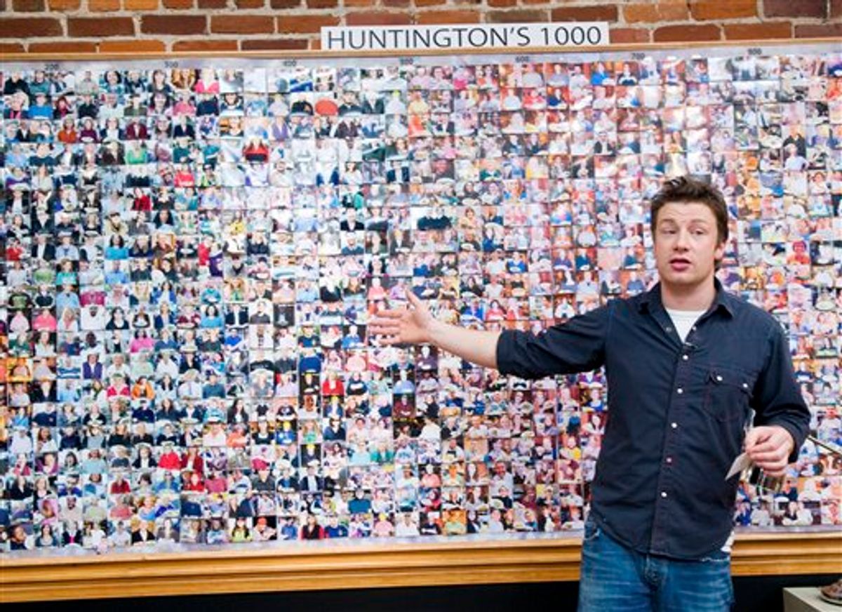 In this publicity image released by ABC, chef and TV personality Jamie Oliver stands in front of a board with photos of residents of Huntington, W. Va., during the taping of his reality series, "Jamie Oliver's Food Revolution," in Huntington, W. Va., airing Friday, March 26, 2010 on ABC.  (AP Photo/ABC, Holly Farrell) NO SALES. (AP)
