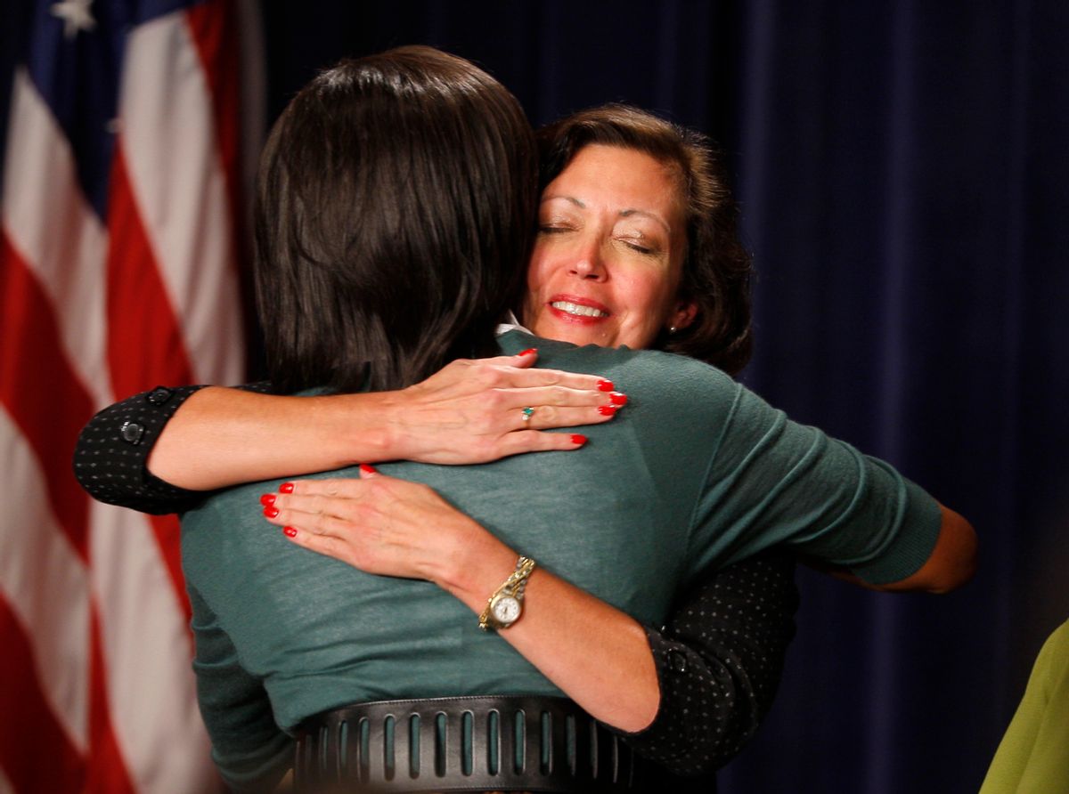Debi Trauth (R) of Cincinatti, Ohio, hugs U.S. first lady Michelle Obama at a health care event at the White House in Washington, September 18, 2009. Trauth is a widow with a teenage son who had difficulty finding a healthcare insurance policy that would cover her because of their pre-existing conditions that included her son with a sprained ankle, and she had taken an antidepressant for 6 months following her husband's long battle with cancer. Michelle Obama joined the U.S. Health Care reform on Friday with an event at the White House where three women shared their healthcare cost on stage with the first lady.   REUTERS/Hyungwon Kang    (UNITED STATES BUSINESS HEALTH POLITICS) (Reuters)