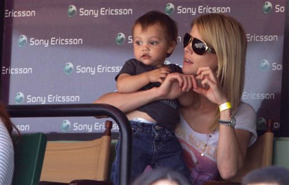 Elin Nordegren, the wife of Tiger Woods, sits with her son Charlie during a semifinal match between Rafael Nadal and Andy Roddick at the Sony Ericsson Open tennis tournament in Key Biscayne, Fla. Friday, April 2, 2010. (AP Photo/Lynne Sladky) (AP)