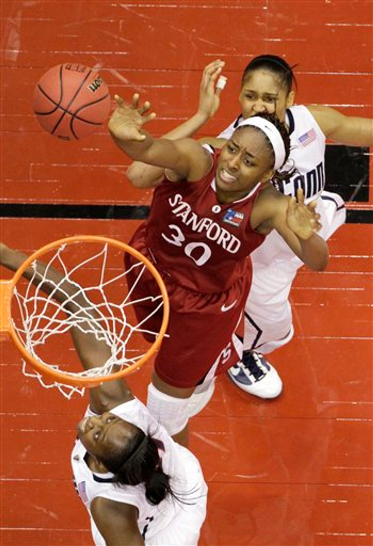 Stanford's Nnemkadi Ogwumike shoots against Connecticut's Tina Charles  and Maya Moore. (AP Photo/Eric Gay)