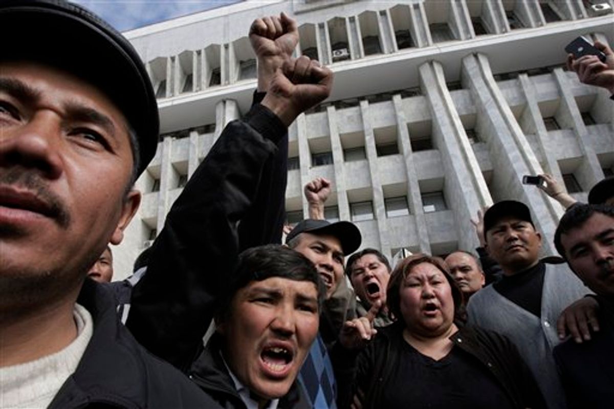 Protesters shout ant government slogans as they gather in front of Kyrgyz government headquarters on the central square in Bishkek, Kyrgyzstan, Thursday, April 8, 2010. An opposition coalition in Kyrgyzstan said it has formed an interim government that will rule the turbulent Central Asian nation for six months. Opposition leader Roza Otunbayeva said Thursday she will head the government that dissolved the parliament and will take up legislative duties.  (AP Photo/Alexander Zemlianichenko) (AP)
