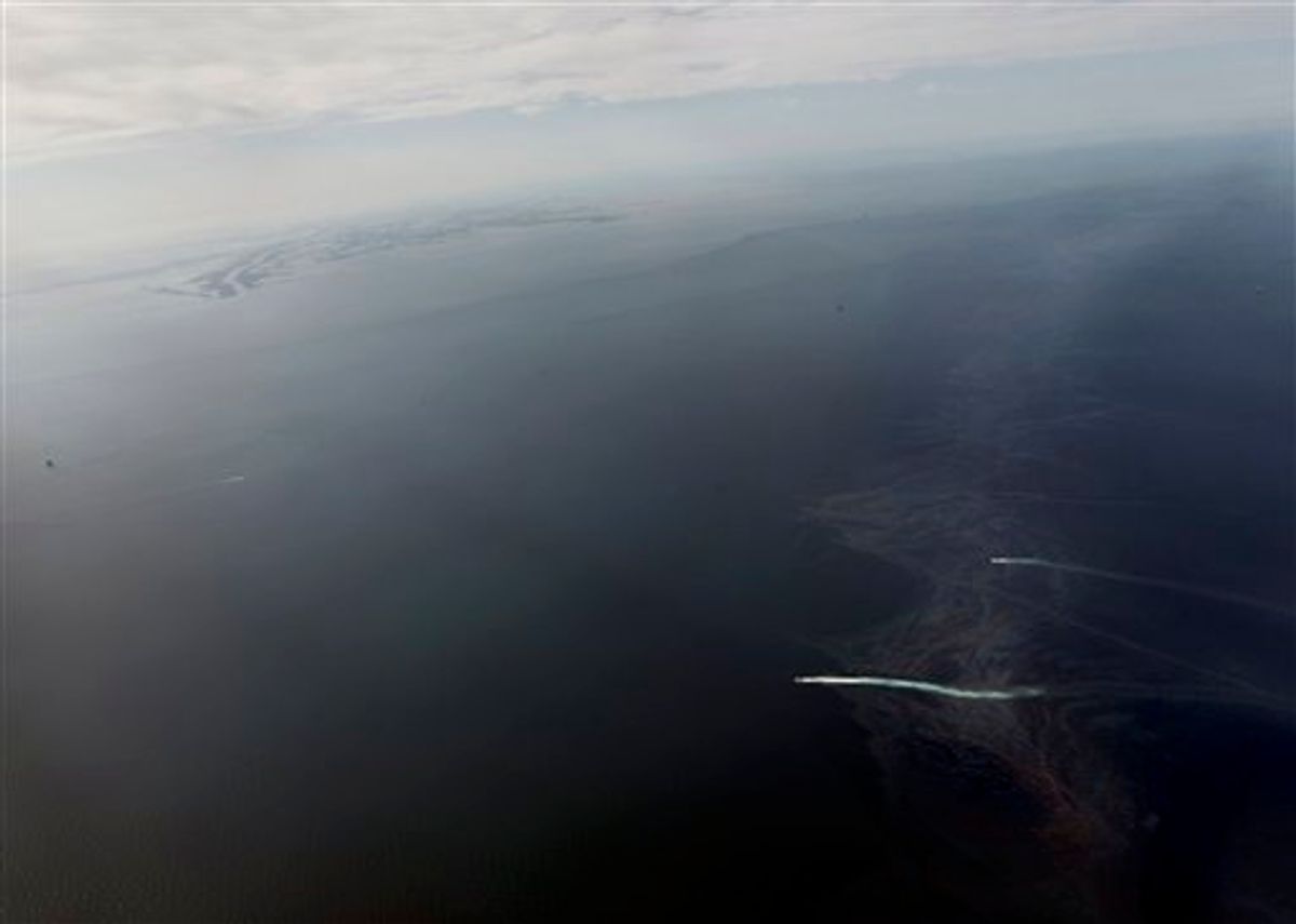 Oil, bottom right, is seen approaching the Louisiana Coast, top left,  in this aerial photo taken 8 miles from shore, Wednesday, April 28, 2010.  The massive oil spill in the Gulf of Mexico is even worse than believed and as the government grows concerned that the rig's operator is ill-equipped to contain it, officials are offering a military response to try to avert a massive environmental disaster along the ecologically fragile U.S. coastline.(AP Photo/Gerald Herbert) (AP)