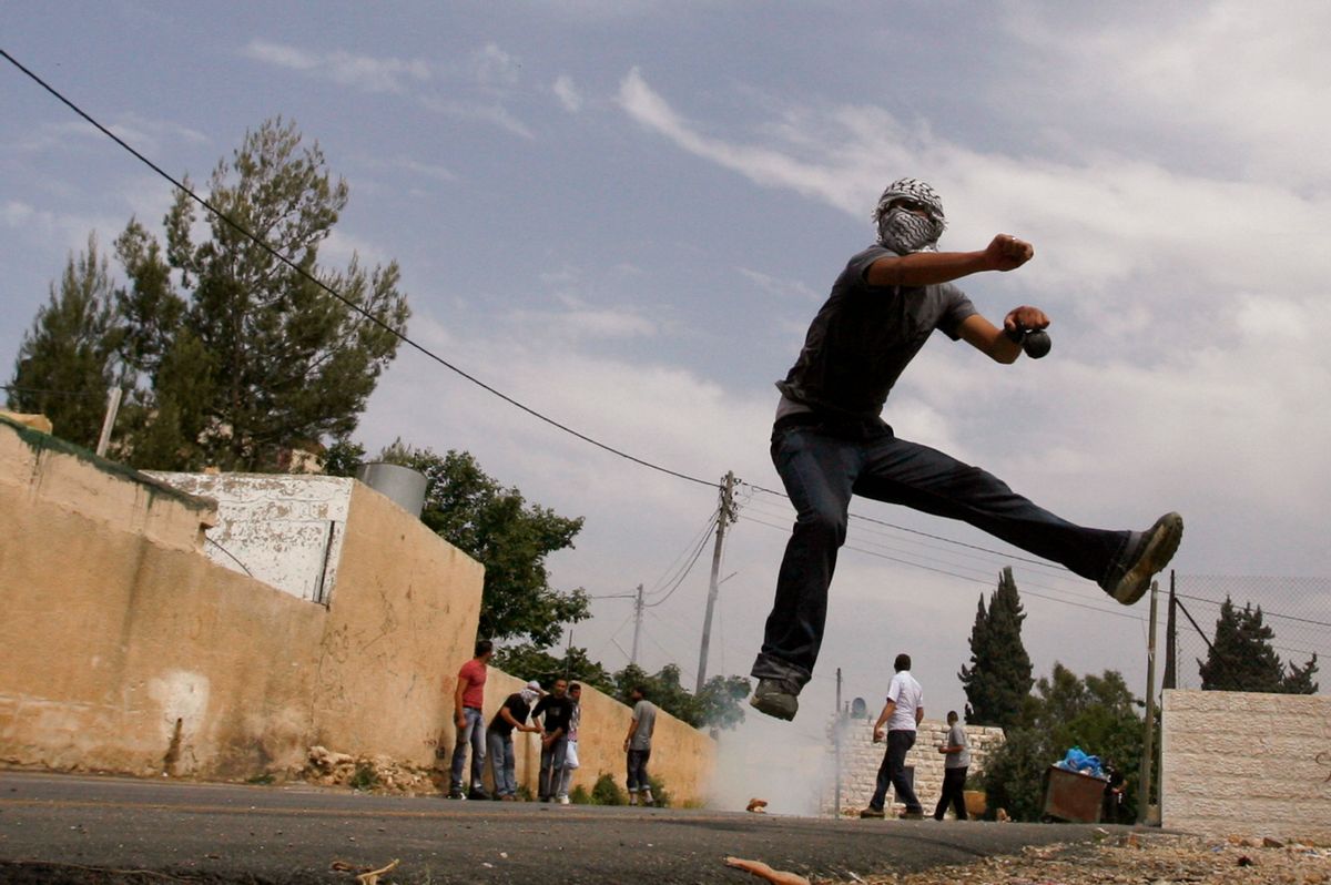 A Palestinian throws a stone towards Israeli border police during clashes in the West Bank village of Nabi Saleh near Ramallah April 16, 2010. Israeli border police used tear gas and rubber bullets to disperse Palestinian protesters and Israeli activists during a violent protest over a land dispute with Jewish settlers in the area. REUTERS/Mohamad Torokman (WEST BANK - Tags: POLITICS CIVIL UNREST IMAGES OF THE DAY)   (Reuters)