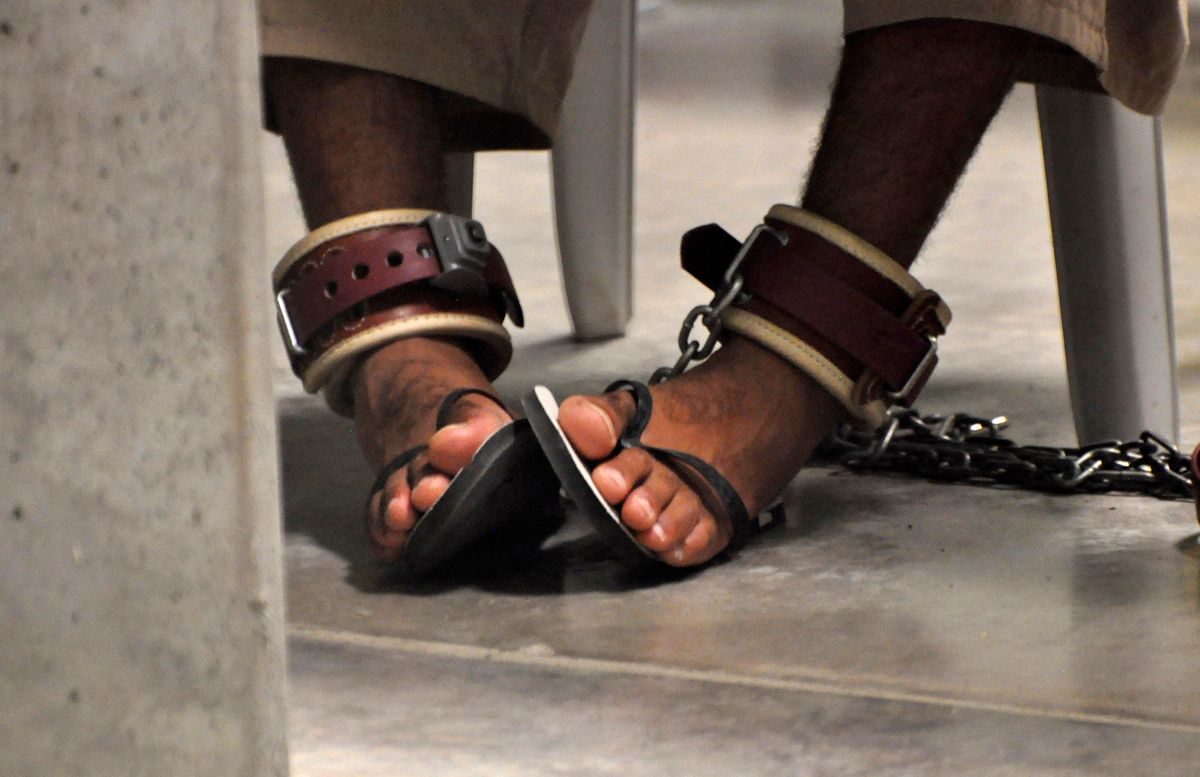 In this photo, reviewed by a U.S. Department of Defense official, a Guantanamo detainee's feet are shackled to the floor as he attends a "Life Skills" class inside the Camp 6 high-security detention facility at Guantanamo Bay U.S. Naval Base April 27, 2010. REUTERS/Michelle Shephard/Pool  (CUBA - Tags: MILITARY POLITICS IMAGES OF THE DAY) (Â© Pool New / Reuters)
