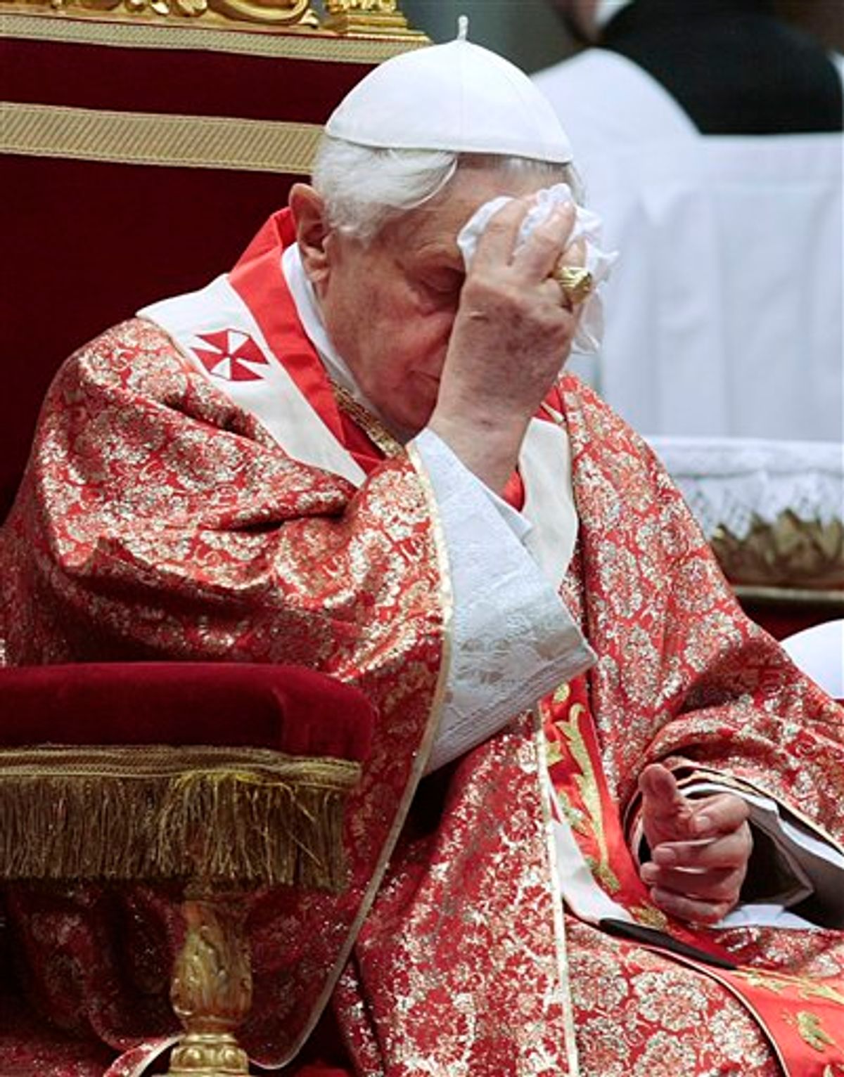 Pope Benedict XVI wipes his forehead as he celebrates a Pentecost Mass inside St. Peter's Basilica, at the Vatican, Sunday, May 23, 2010. (AP Photo/Gregorio Borgia) (AP)