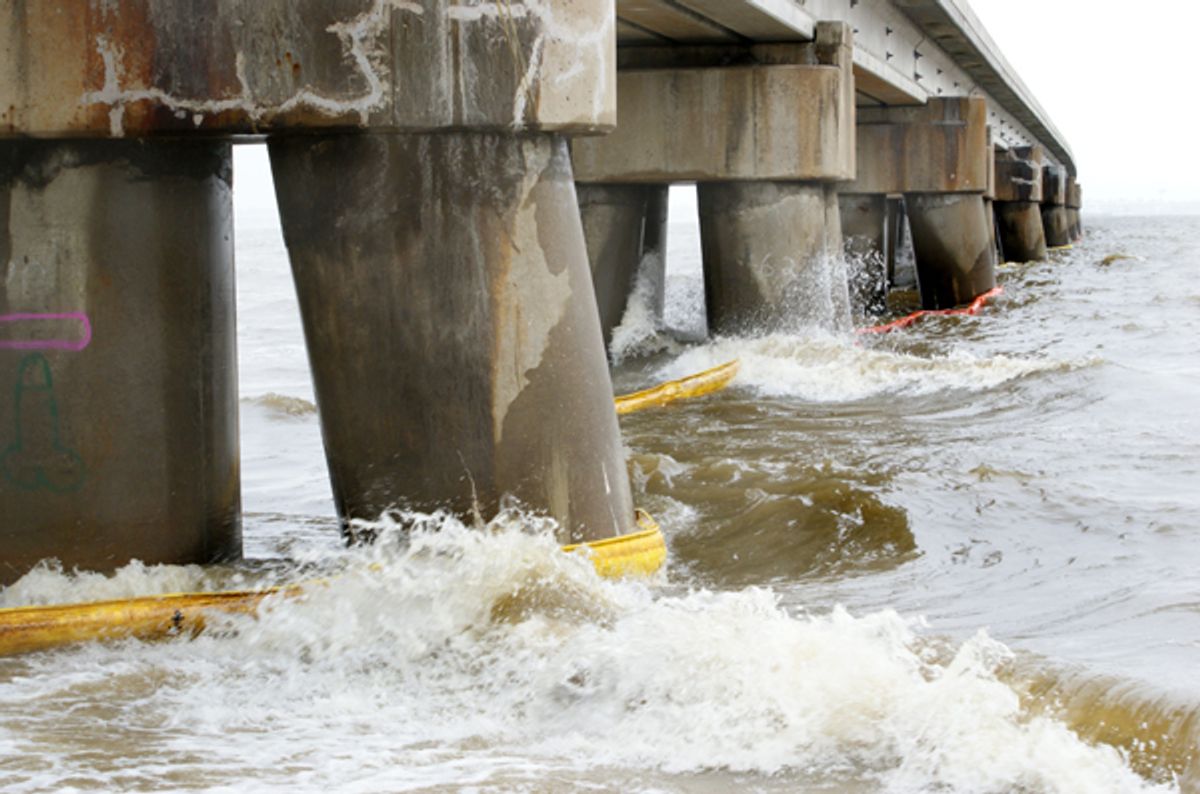 A crude orange and yellow barrier designed to keep the Gulf Coast oil spill from reaching the shores of Bay St. Louis, Mississippi is no match for the waves.