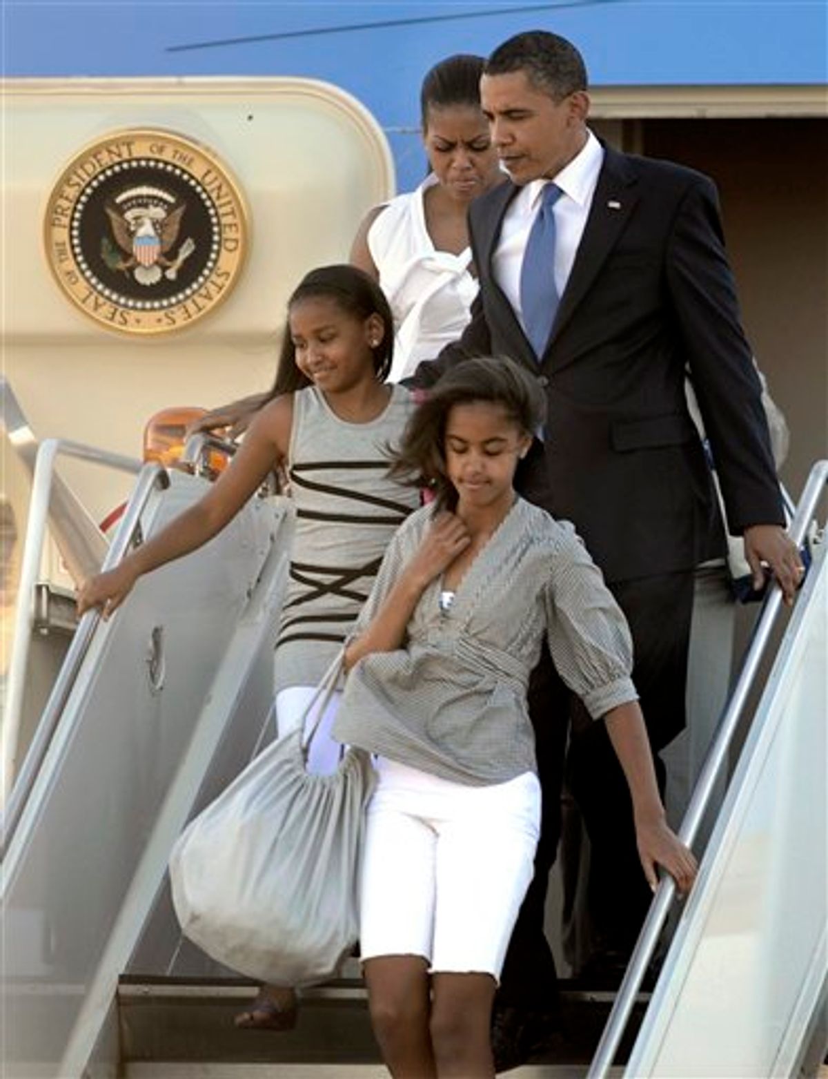 President Barack Obama, first lady  Michelle Obama, along with daughters Malia, front, and Sasha walk off Air Force One after arriving at Chicago O'Hare International Airport in Chicago, Thursday, May 27, 2010. (AP Photo/Paul Beaty) (AP)
