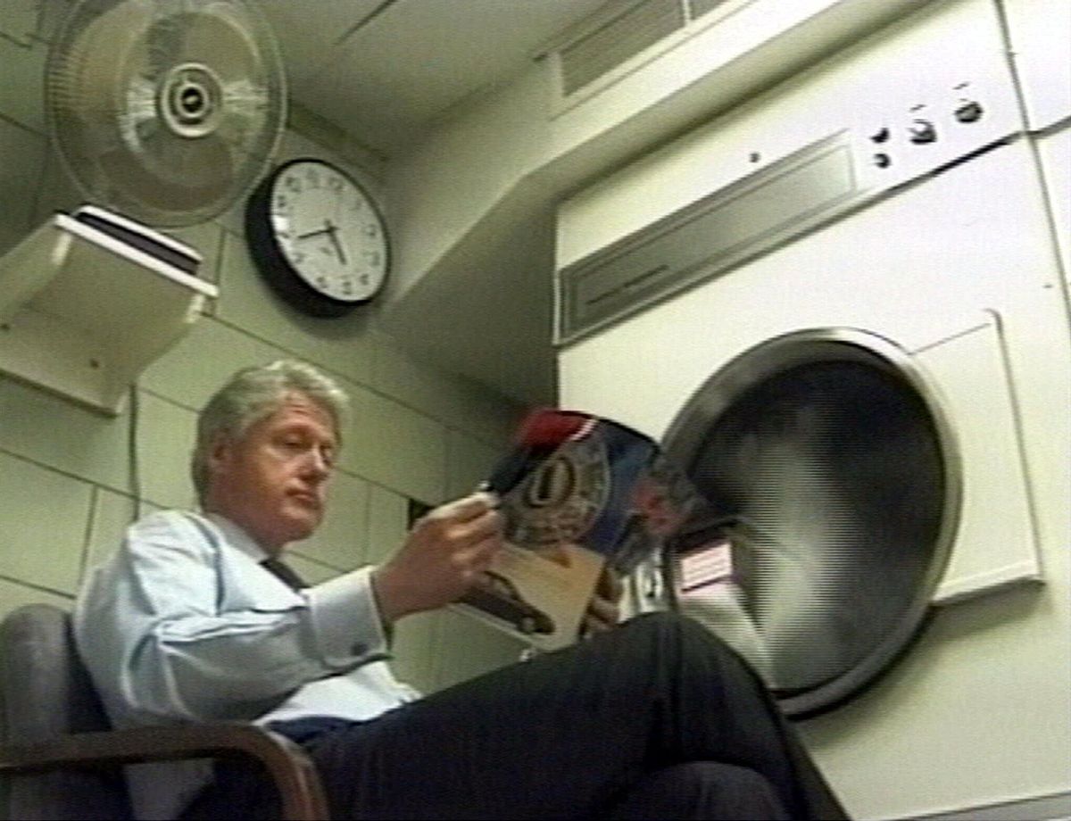 U.S. President Bill Clinton reads a magazines as he waits for his laundry in a still from the mock video he staged for the annual White House Correspondent's Dinner, released Saturday, April 30, 2000. The president, his wife Hillary, and a cast of White House secretaries and advisors took to the stage in a light-hearted film marking the end of Clinton's period in office. (AP Photo/White House Production) (Associated Press)
